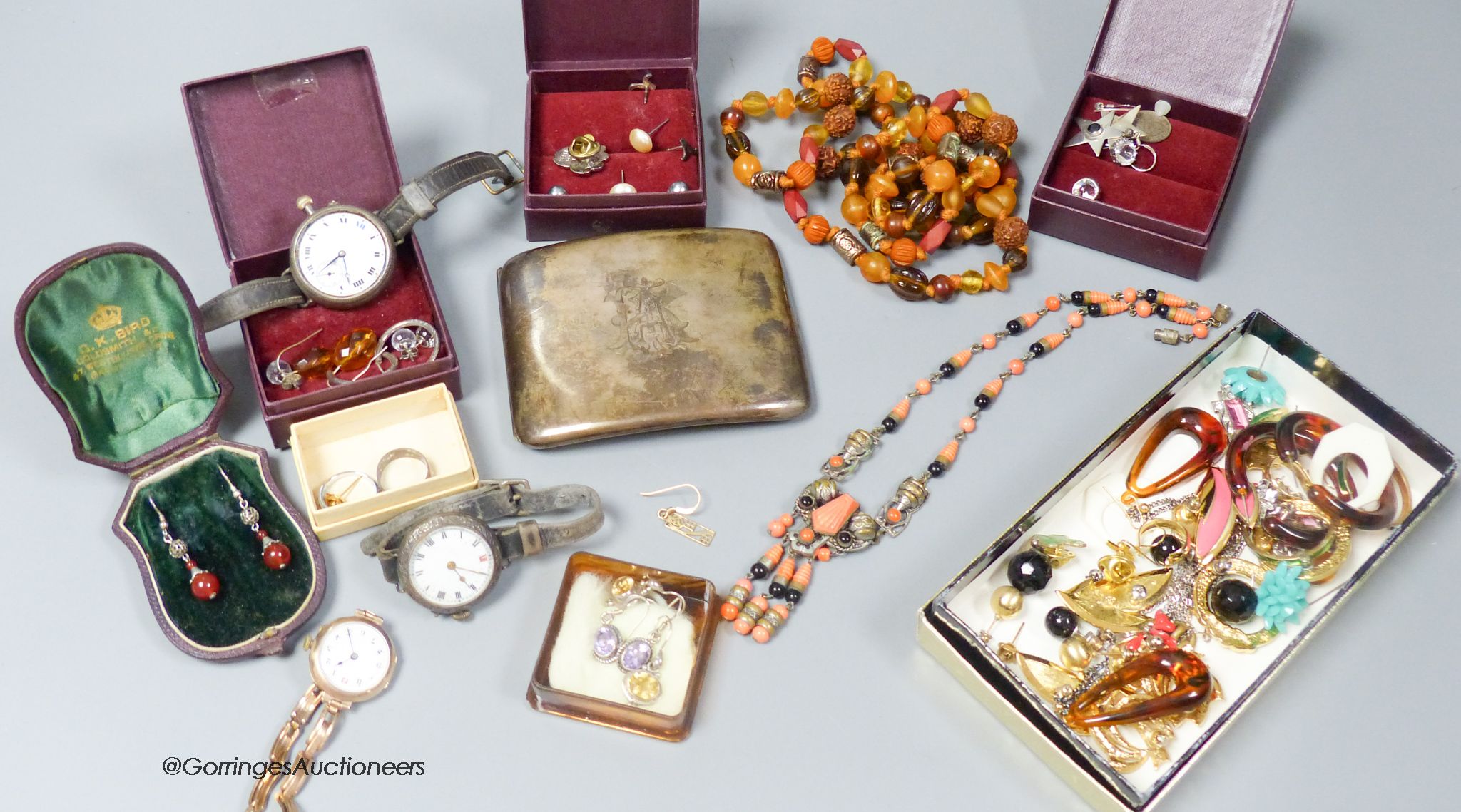 A lady's early 20th century 9ct gold manual wind wrist watch, on a 9ct flexible bracelet, gross 19.6 grams, two other white meta wrist watches, a silver cigarette case and assorted costume jewellery.